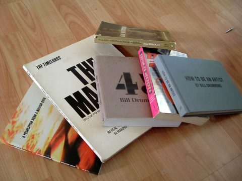 Pile of KLF-related books on wooden floor