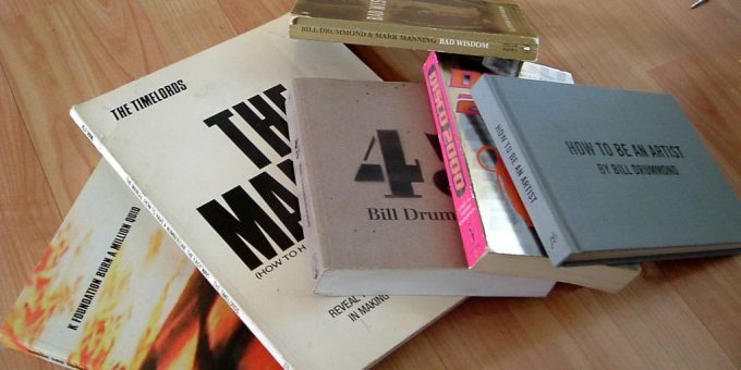Pile of KLF-related books on wooden floor